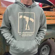 Load image into Gallery viewer, Person wearing a green hoodie with a Portage Icon design in front of a vintage truck 

